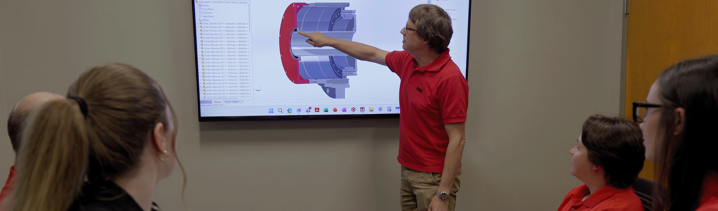 Engineer pointing to the monitor while others watching