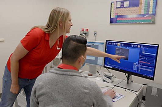 Engineers at computer on software program